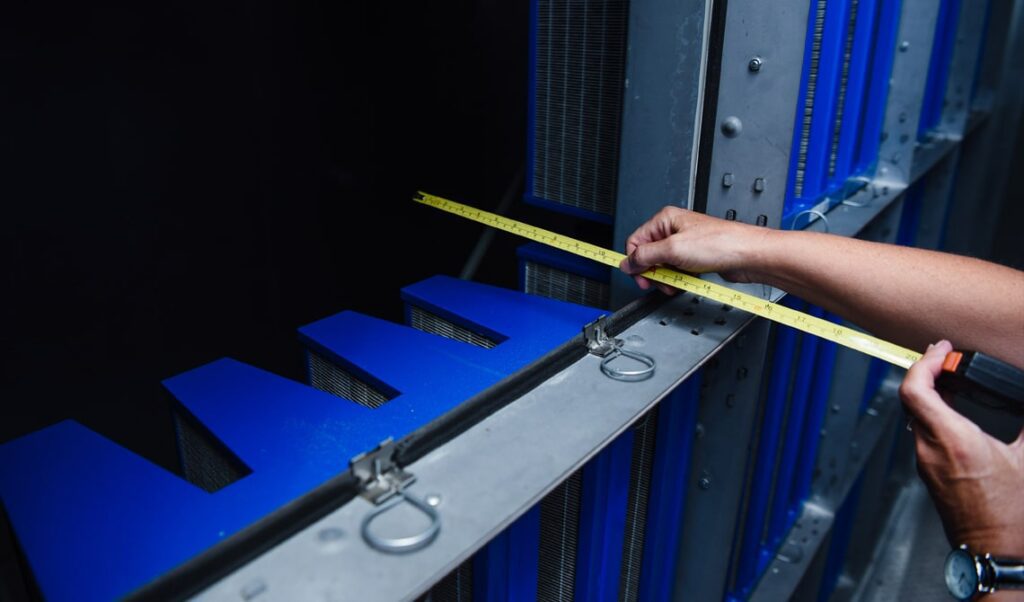 air filter tech measuring air handler unit frame depth to install proper filters