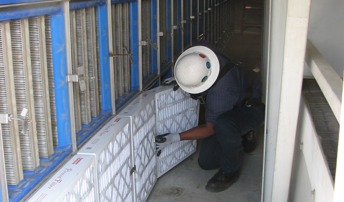 AFC filter tech installing air filters inside air handler unit