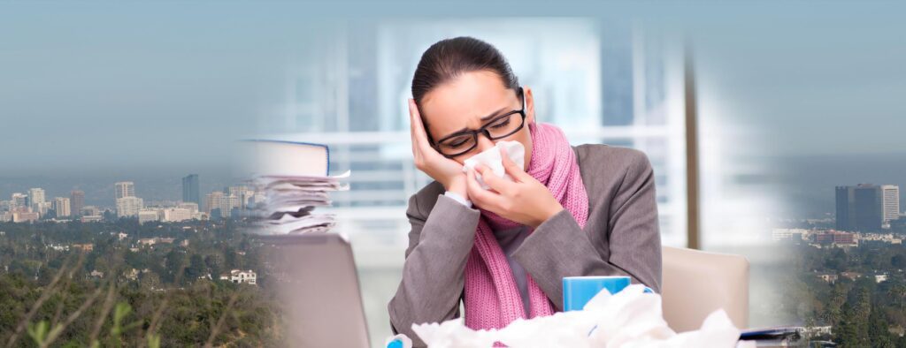 Employee blowing nose in workplace